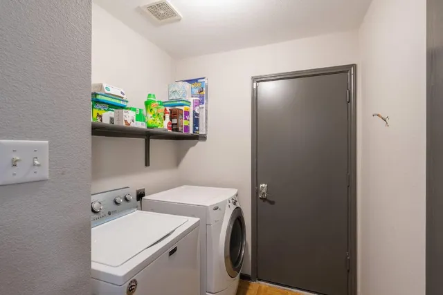 a backyard of a house with table and chairs