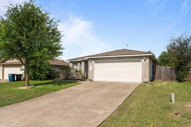 a view of a house with a yard and garage