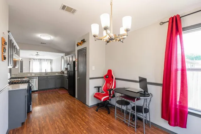 a very nice looking room with a dining table chairs and wooden floor