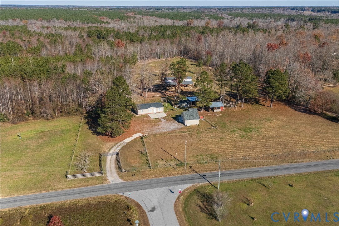 14306 Wilkinson Road Dewitt, VA 23840 - Photo 46 of 60 Gravel driveway with a wooden fence, surrounded by