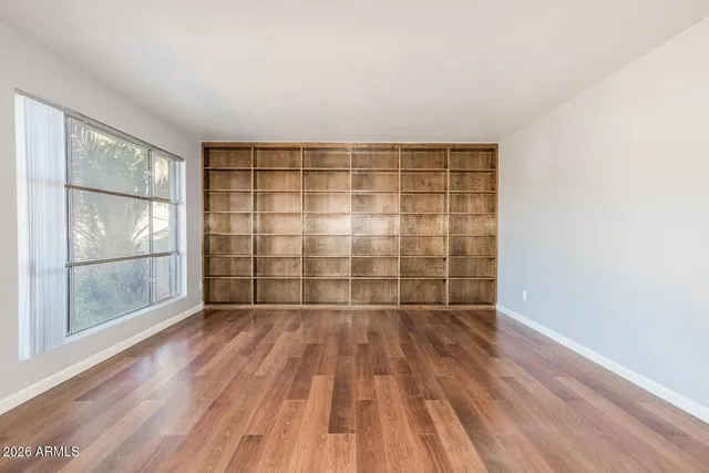 wooden floor in an empty room with a window