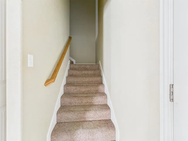 a view of staircase with white walls