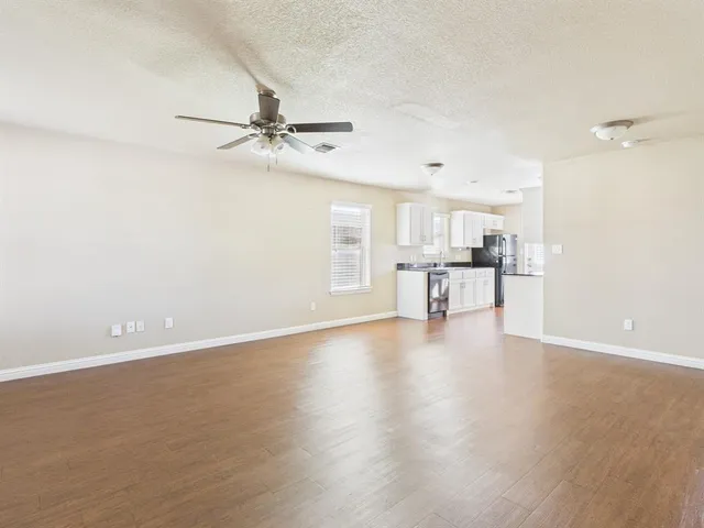 a view of a kitchen with a dishwasher and a refrigerator