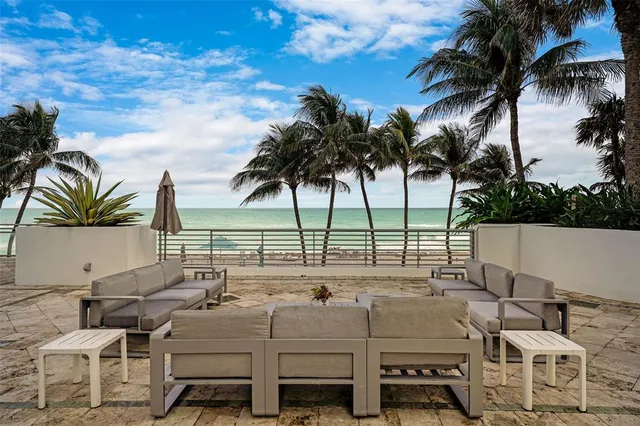 a front view of a building with outdoor seating