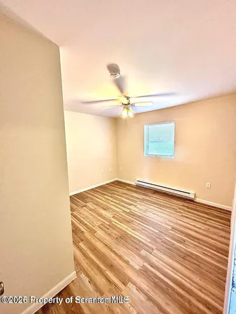 a view of a room with wooden floor