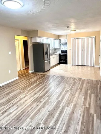 a view of a livingroom with wooden floor