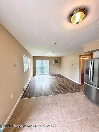 a view of a room with wooden floor and window