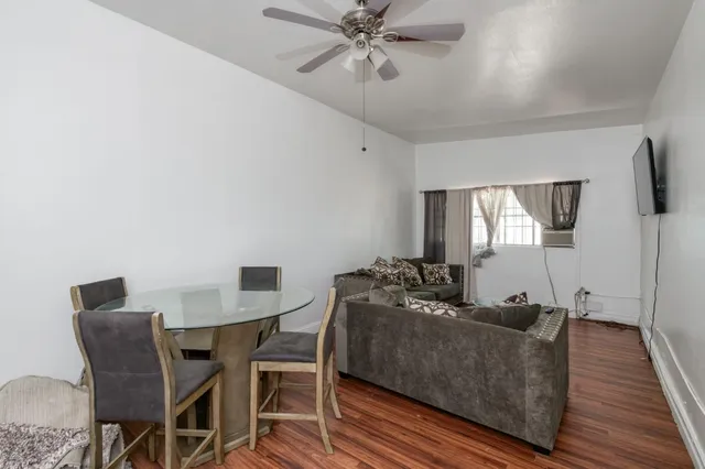 a view of a dining room with furniture and wooden floor