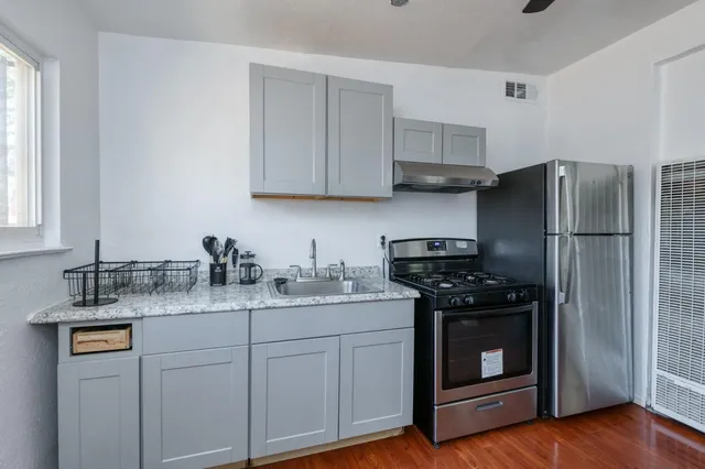a bathroom with a sink a toilet a mirror and shower curtain