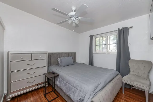 a view of a hallway and wooden floor and a livingroom with furniture