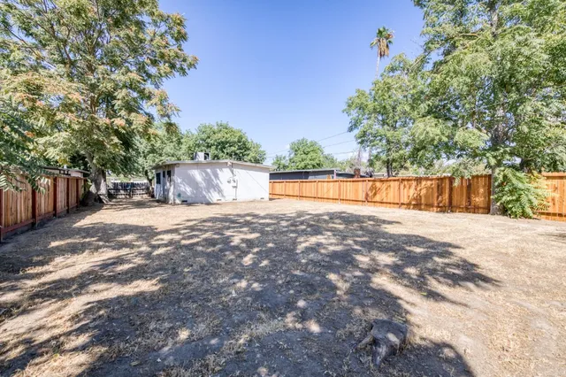 a backyard of a house with wooden fence