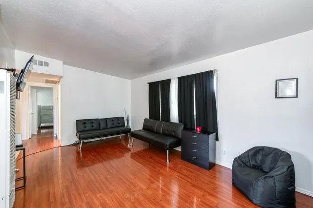 a view of a livingroom with furniture and wooden floor