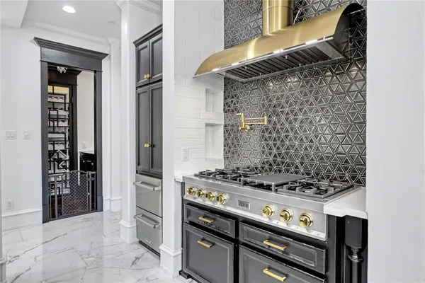 a kitchen with granite countertop a sink a counter space appliances and cabinets