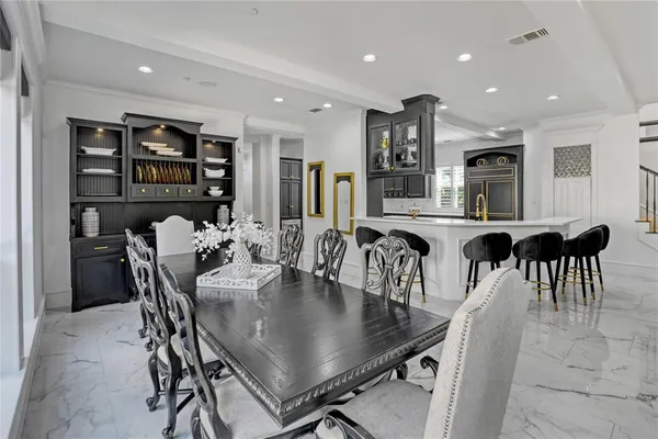 a living room with furniture a fireplace and a chandelier