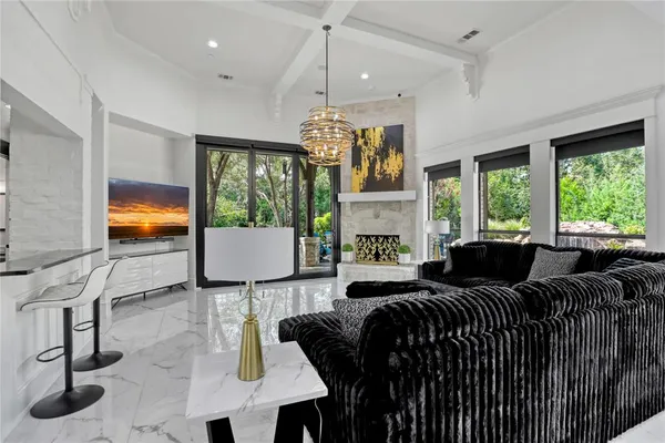 a living room with furniture and a chandelier