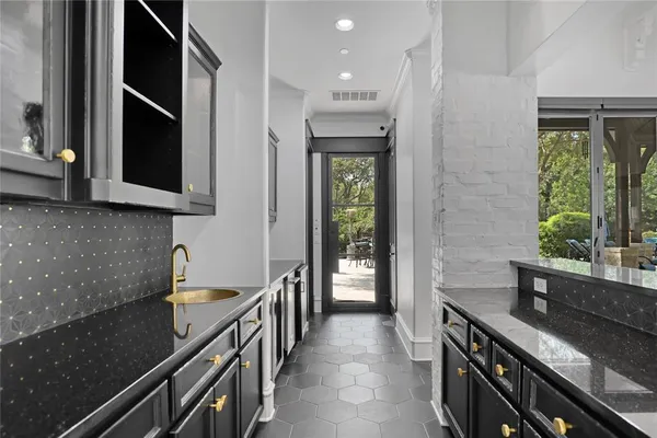a kitchen with granite countertop sink and cabinets