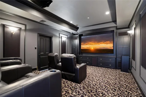 a room with table chairs and flat screen tv