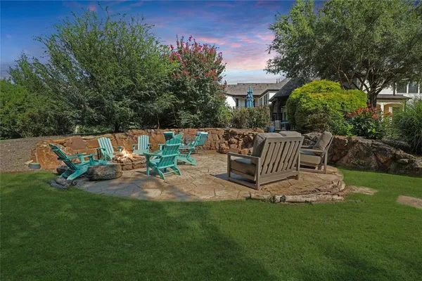 a view of a chair and table in backyard