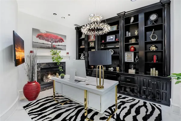 a workspace with furniture a chandelier and window