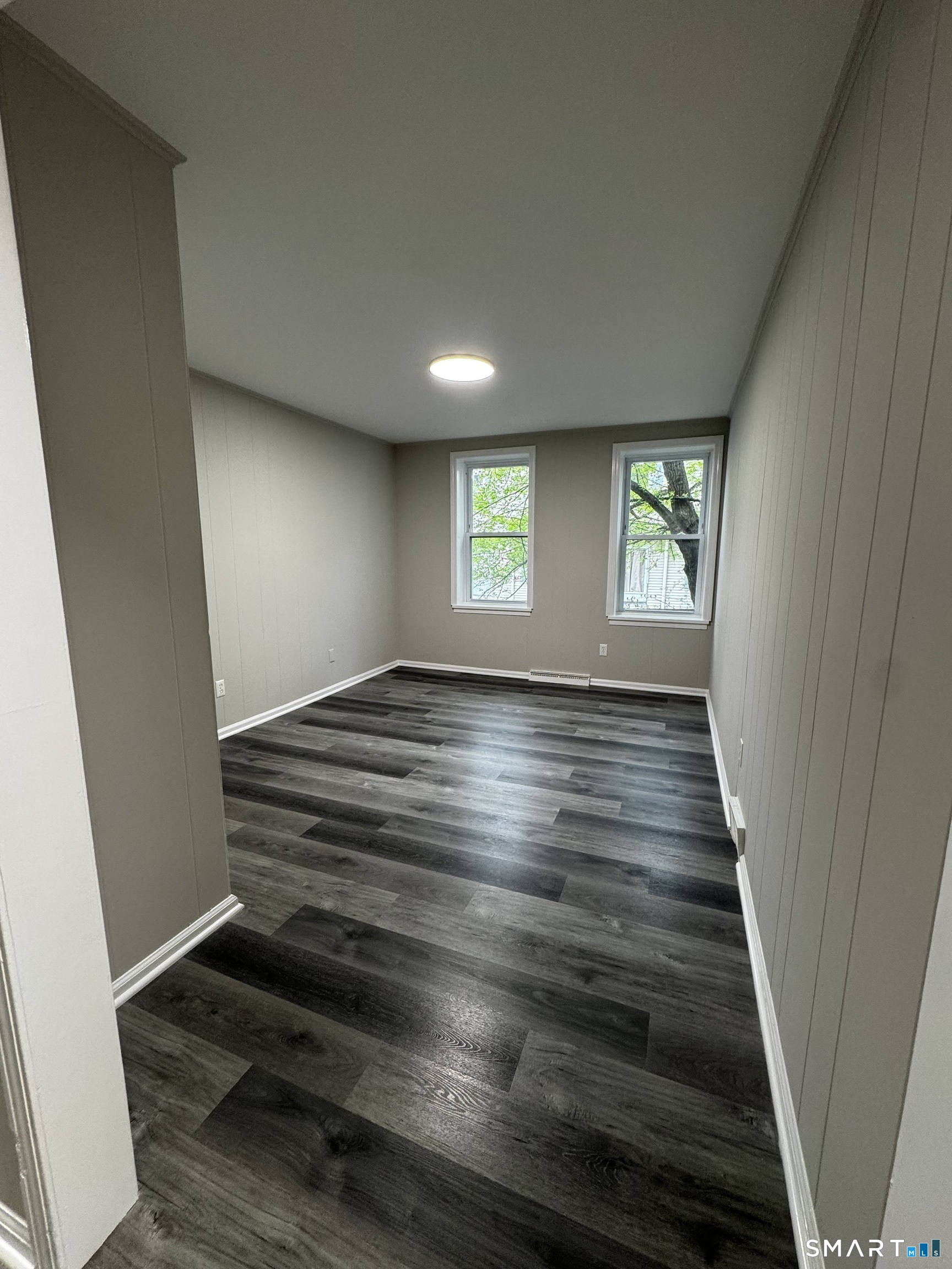 45-51 Cowles Street, Unit 45 Bridgeport, CT 06607 - Photo 8 of 33 the living room with tons of natural light, is completely remodeled with new flooring, new lighting and new paint