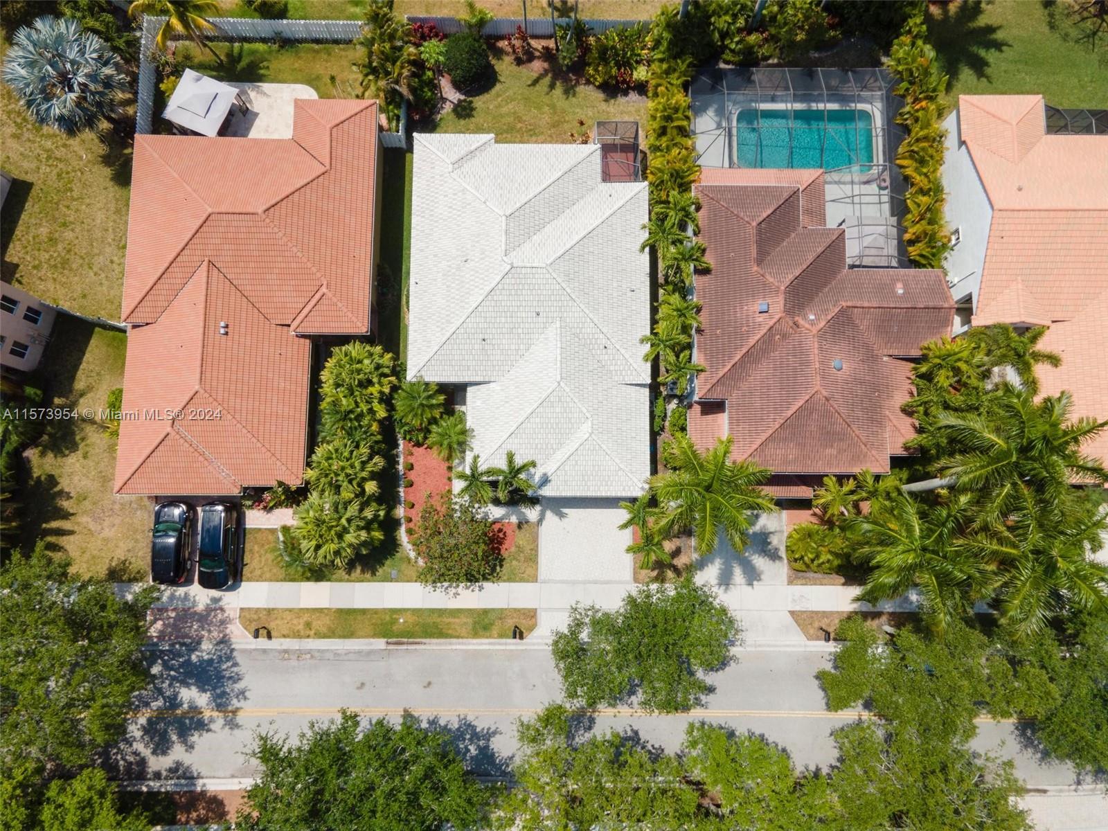 an aerial view of a house with a garden and swimming pool
