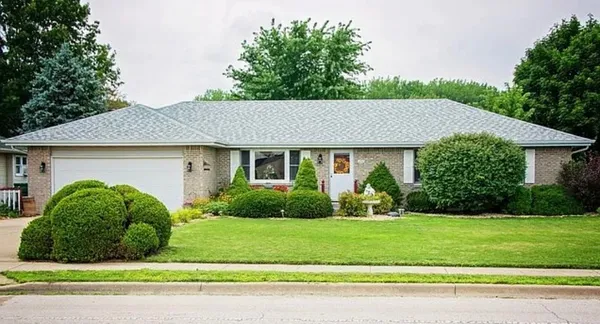 a view of a house with a yard and plants