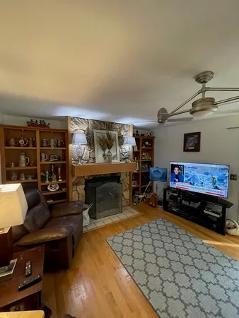 a dining room with furniture and wooden floor