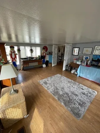 a bedroom with double bed and a couch