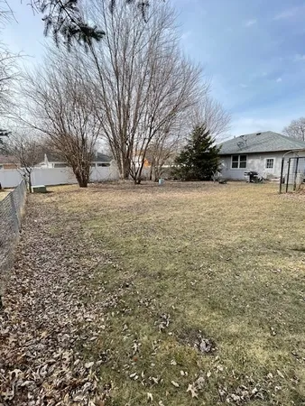 a view of a house with yard and sitting area