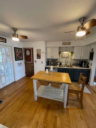 a living room with lots of furniture and kitchen view