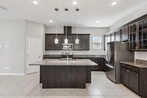 a kitchen with a sink a stove and cabinets