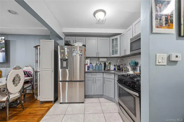 a kitchen with stainless steel appliances granite countertop a refrigerator and a stove top oven