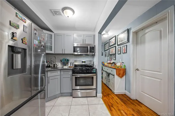 a kitchen with stainless steel appliances granite countertop a refrigerator and a stove