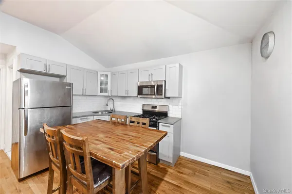 a kitchen with stainless steel appliances a refrigerator and a stove top oven