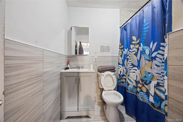 a white toilet sitting next to a bathroom sink