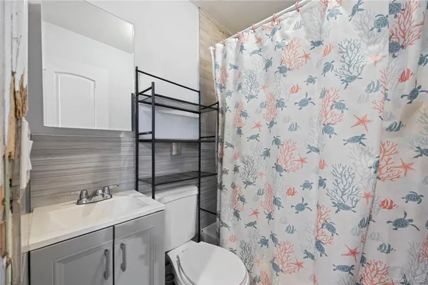 a bathroom with a sink toilet and mirror