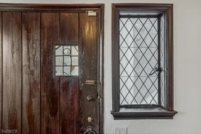 a living room with furniture two window and wooden floor