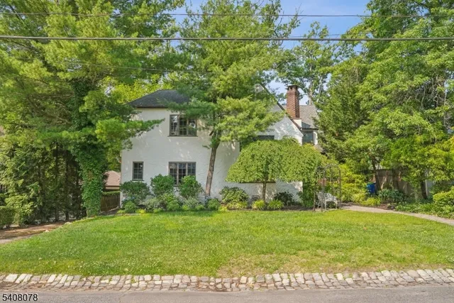 a view of a house with backyard sitting area and garden
