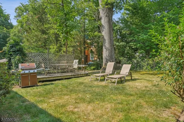 a living room with furniture a flat screen tv and a large window