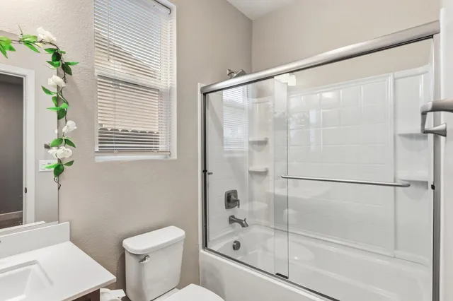 a bathroom with a shower and a toilet