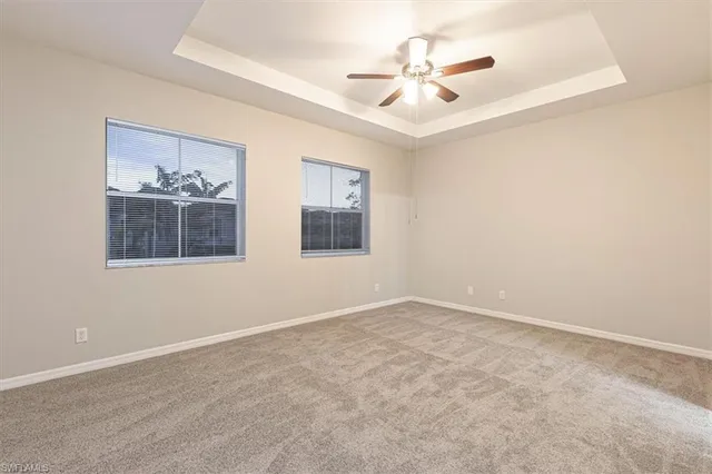 an empty room with closet and a chandelier fan