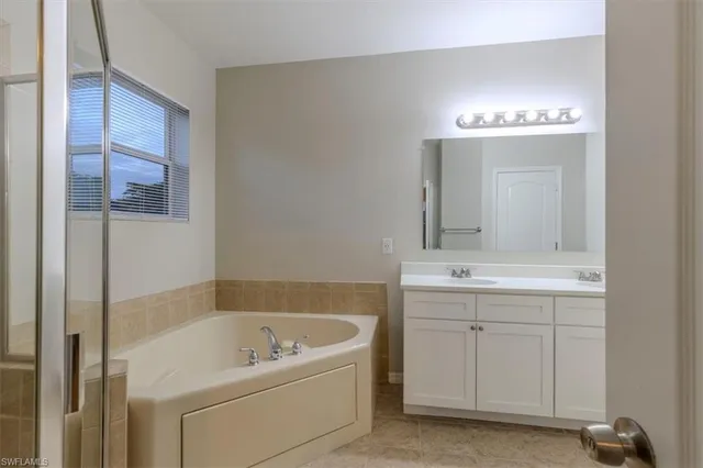 an empty room with closet and a ceiling fan