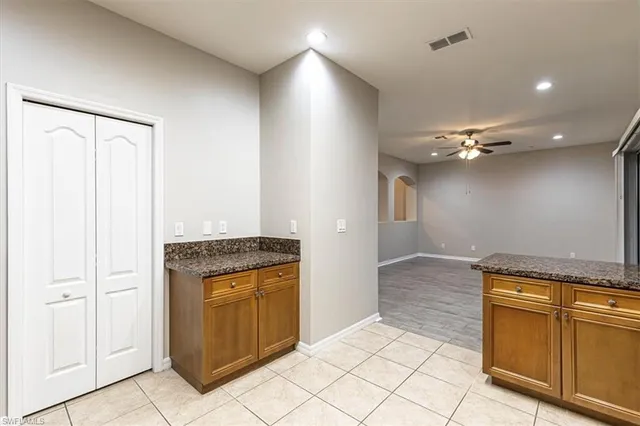 a kitchen with stainless steel appliances granite countertop a refrigerator stove top oven and sink