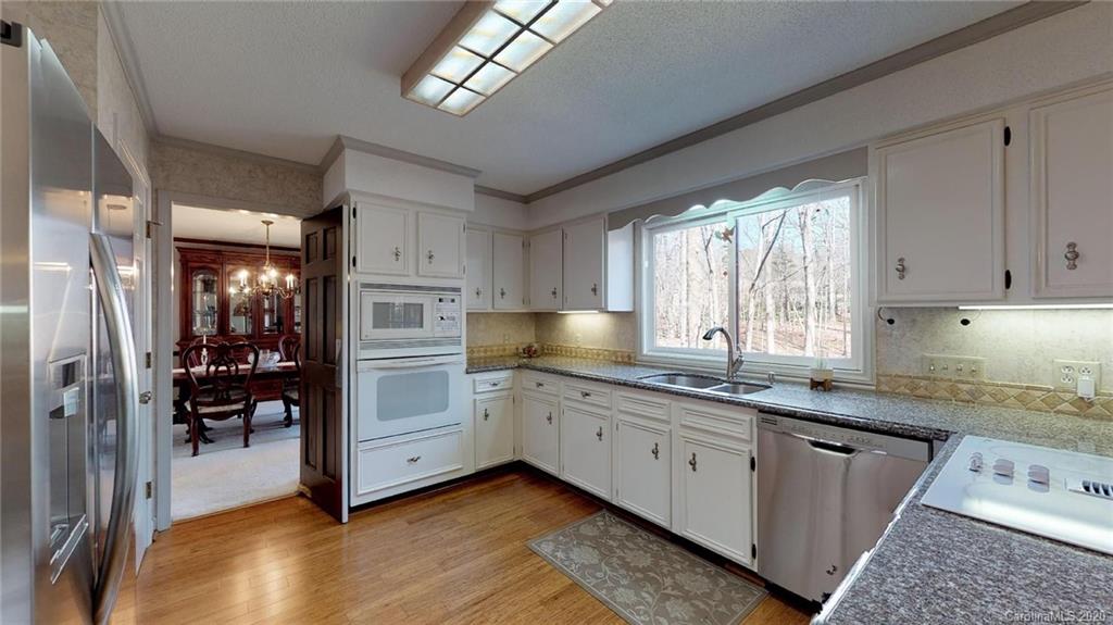 3002 High Ridge Road Charlotte, NC 28270 - Photo 13 of 41 a kitchen that has a lot of cabinets in it and wooden floors
