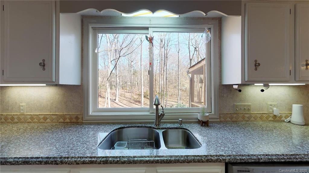 3002 High Ridge Road Charlotte, NC 28270 - Photo 14 of 41 a kitchen with granite countertop a sink a counter and cabinets