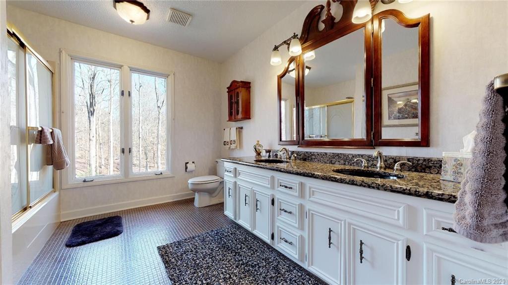 3002 High Ridge Road Charlotte, NC 28270 - Photo 28 of 41 a bathroom with a double vanity sink a mirror and a bathtub