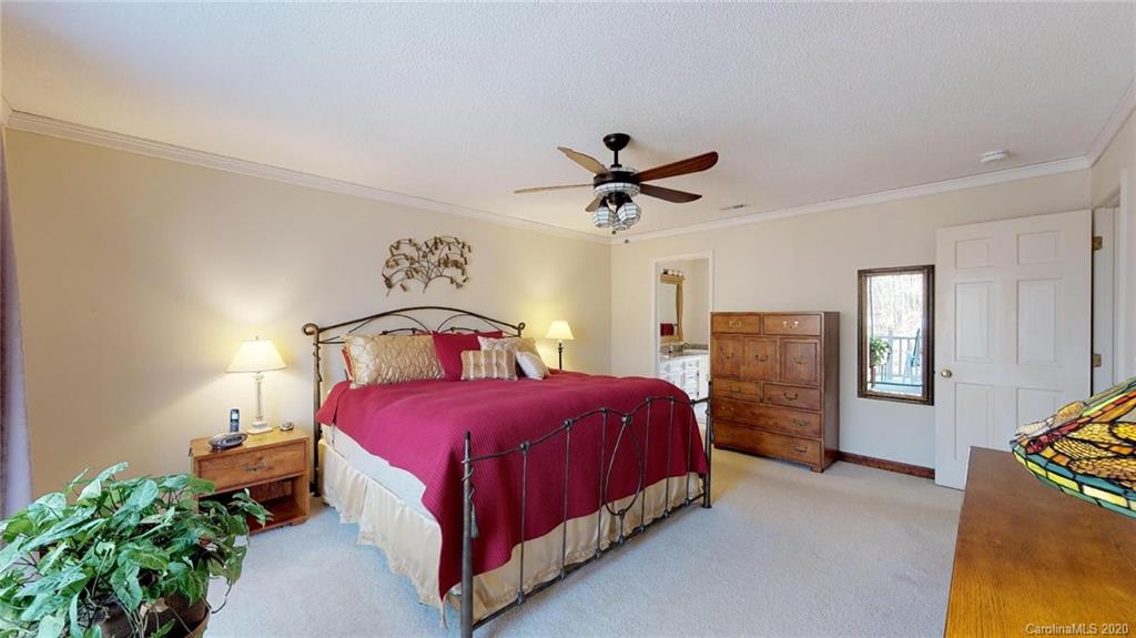 3002 High Ridge Road Charlotte, NC 28270 - Photo 30 of 41 a bedroom with a bed and a chandelier