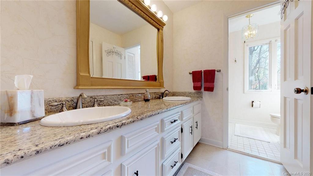 3002 High Ridge Road Charlotte, NC 28270 - Photo 32 of 41 a bathroom with a granite countertop double vanity sink mirror and bathtub
