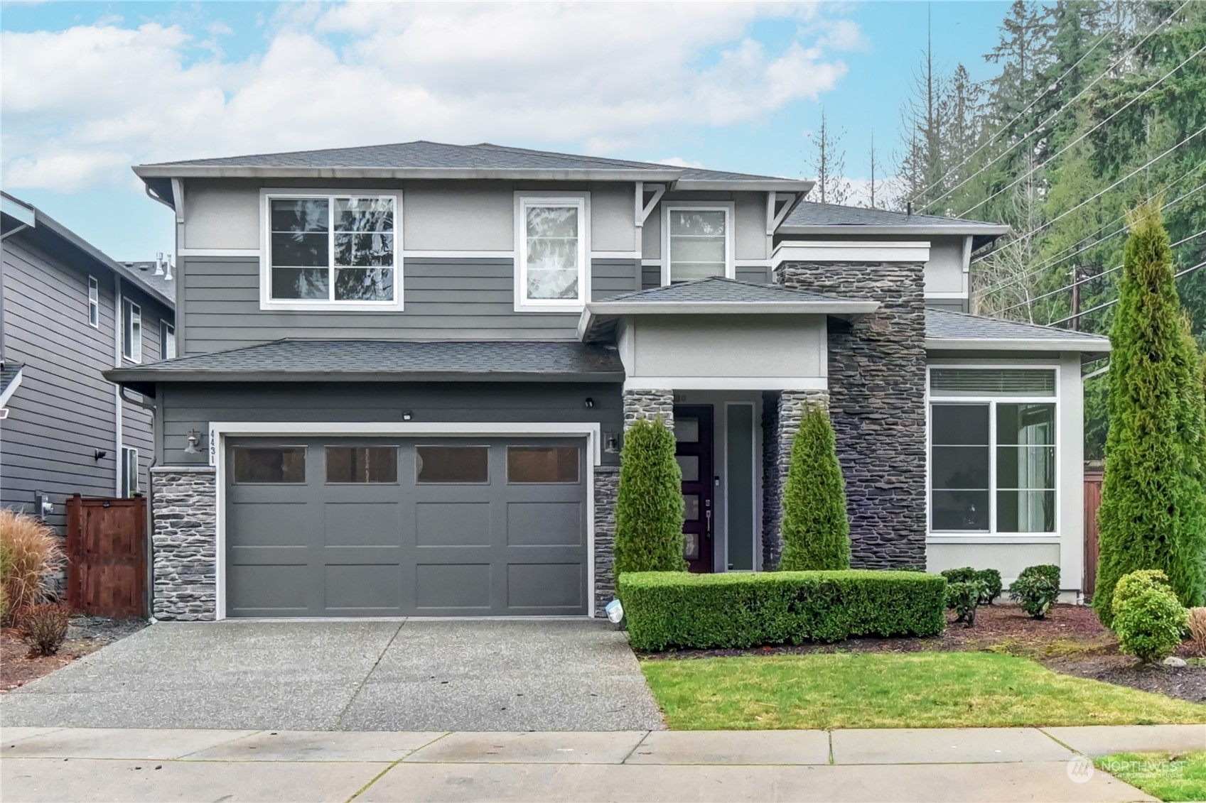 a front view of a house with a yard and garage