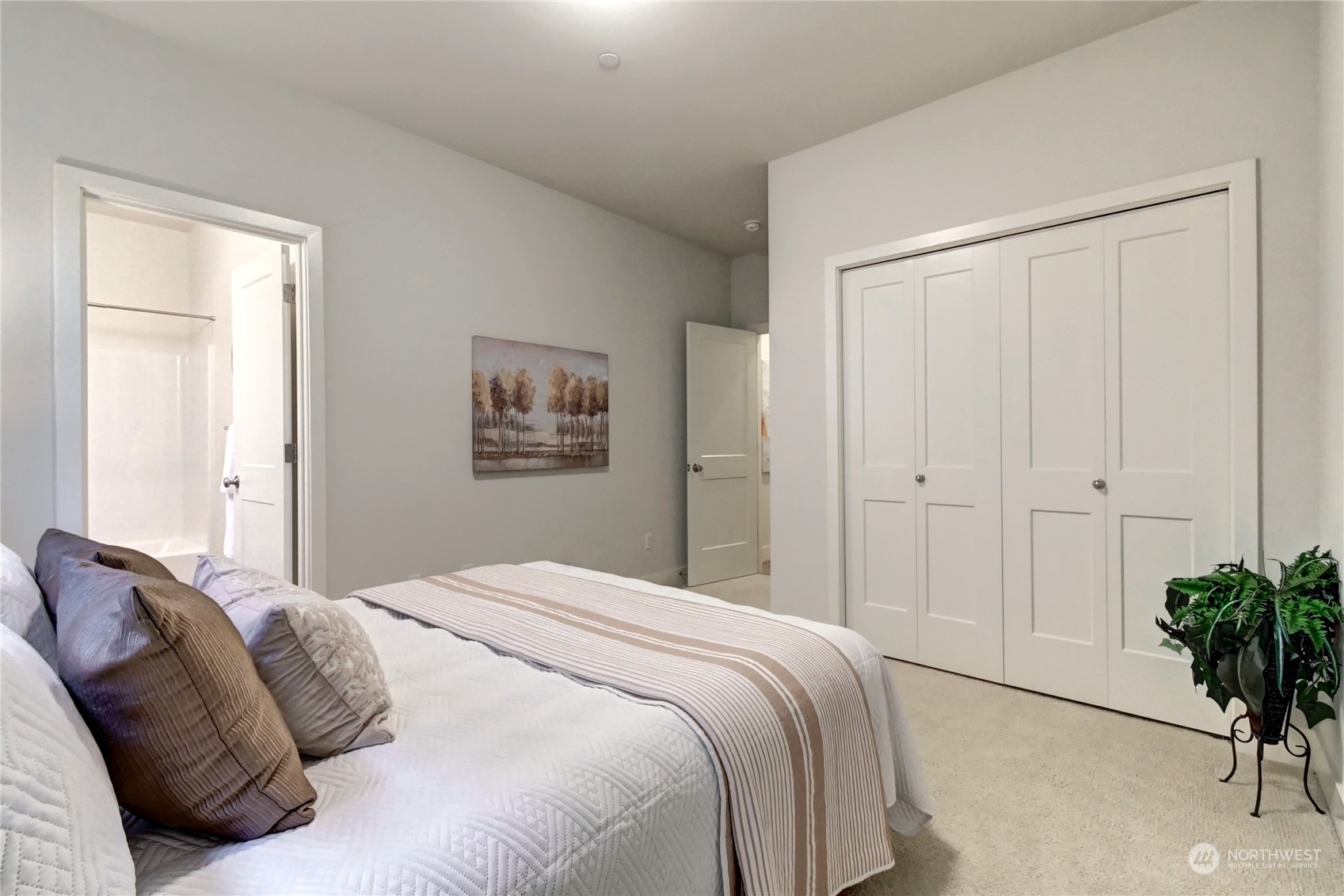 4431 231st Place Southeast Bothell, WA 98021 - Photo 17 of 36 a bedroom with a bed and a potted plant